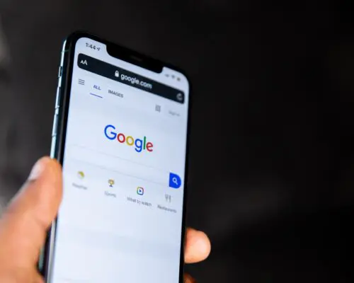 Homepage of Google on the screen of a smartphone.