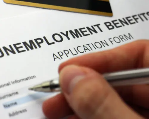 Someone completing an unemployment benefits form.