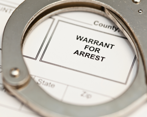 A handcuff circling a paper that says