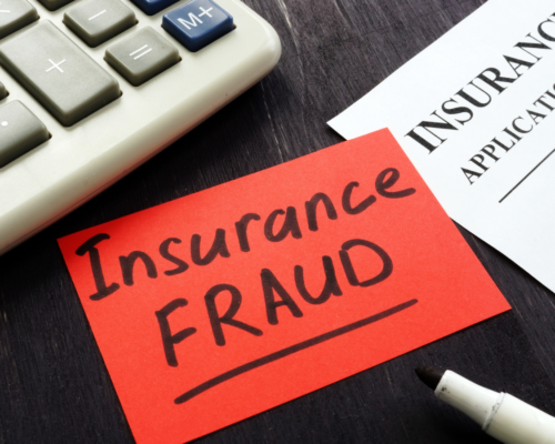 Insurance fraud on a post it on a desk