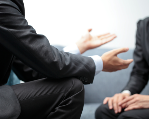 Two business professionals talking to one another