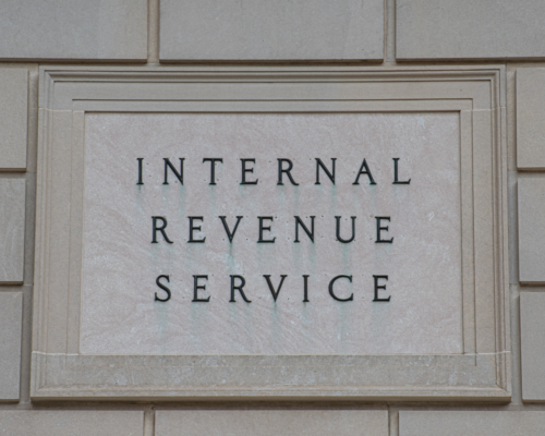 A close up of a concrete sign reading international revenue service.