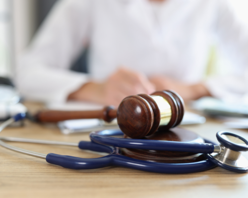 A judges gavel in front of a judge