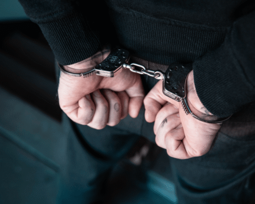Arrested man with cuffed hands