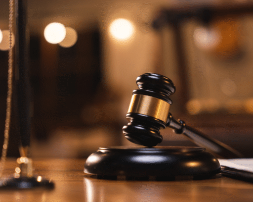 Judge's gavel and scales of justice representing public corruption investigations, misuse of government resources, ethics violations, and white collar criminal defense.