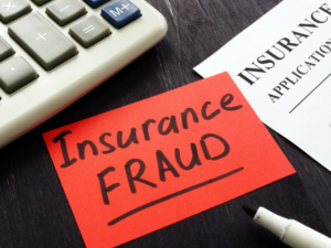 Insurance fraud on a post it on a desk