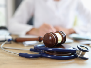 A judges gavel in front of a judge